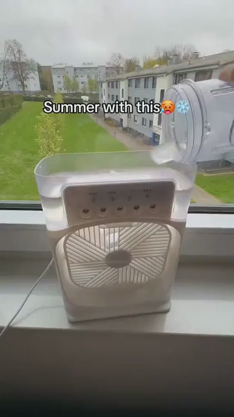 Mini portable air cooler fan on windowsill – compact personal cooling device for summer